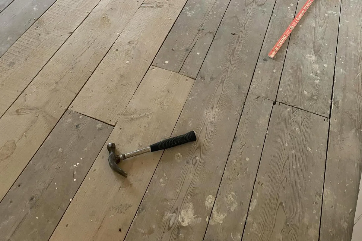 Timber floorboards prepared with carpet gripper rods before underlay installation