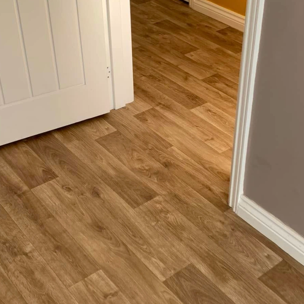 Trimmed white internal door fitted neatly above wood-effect flooring