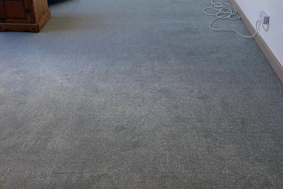 Grey carpet fitted throughout a converted loft room with exposed beams