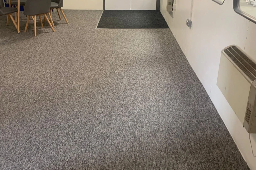 Grey commercial carpet fitted in a workplace staff room