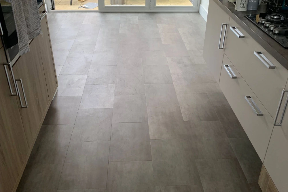 Grey tile-effect vinyl flooring fitted in a modern kitchen