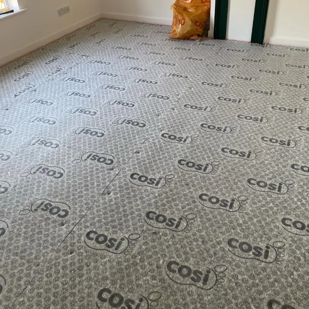 Carpet underlay fitted across a living room ready for new carpet