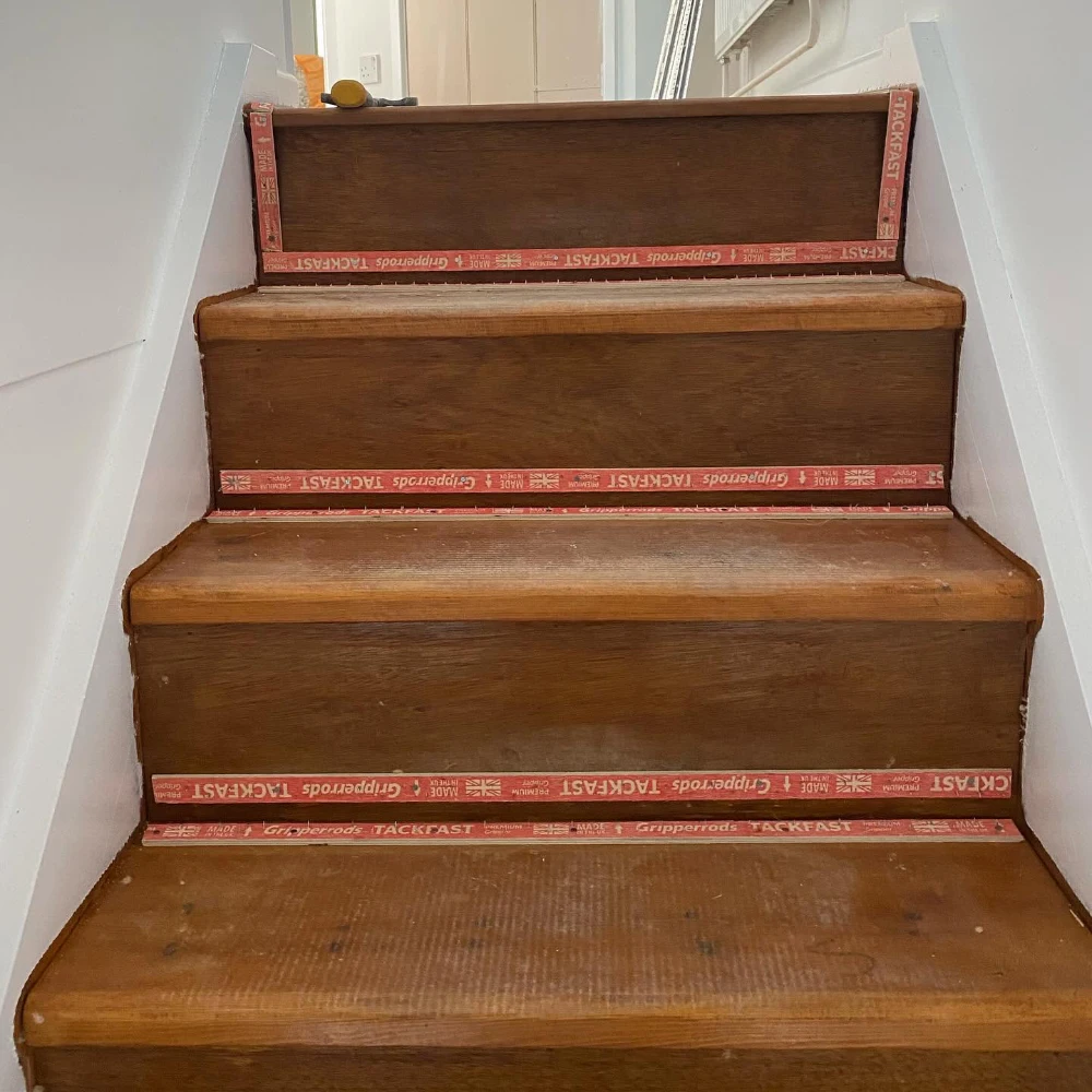 Wooden staircase prepared with carpet gripper rods ready for fitting
