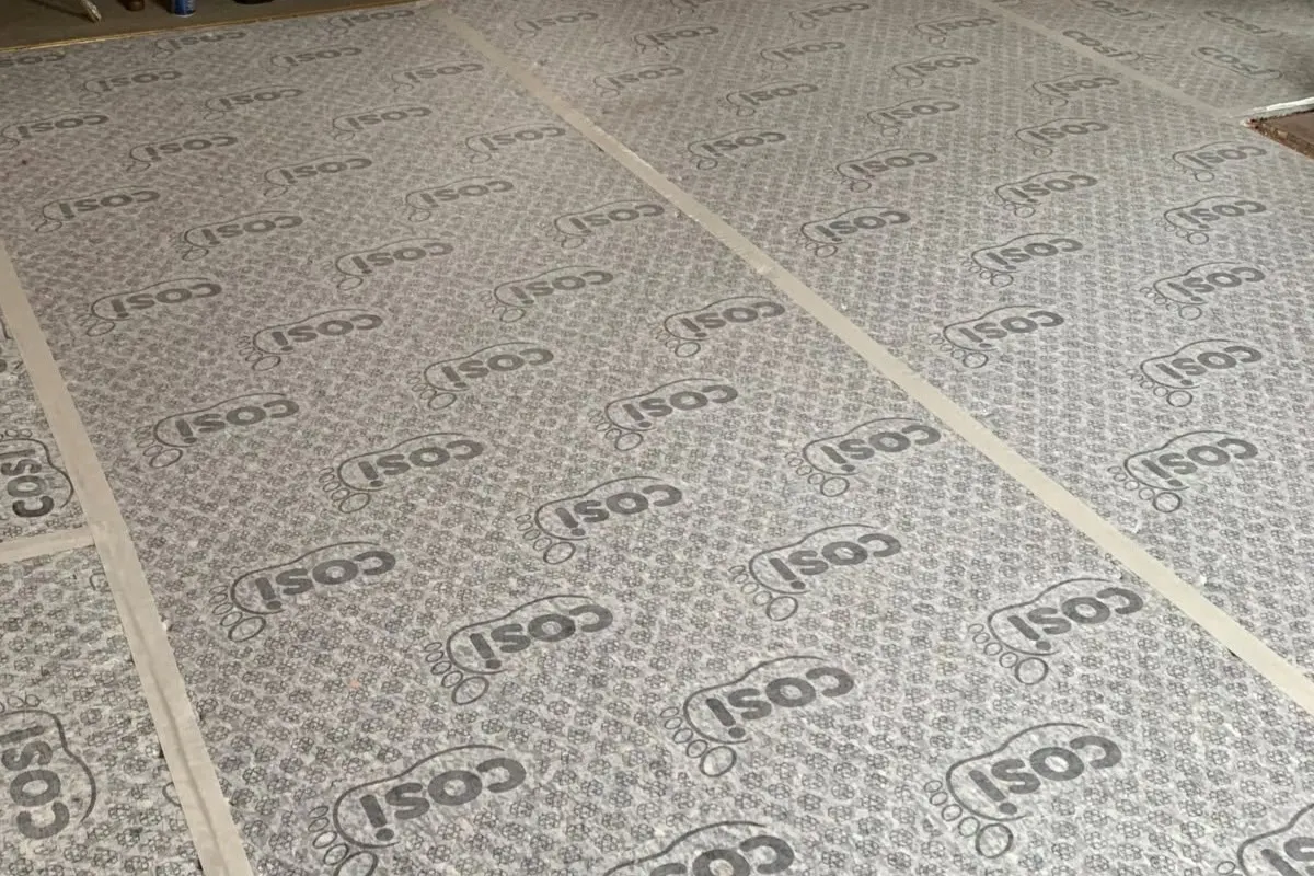 Sub-floor preparation underlay laid across a living room floor before installation