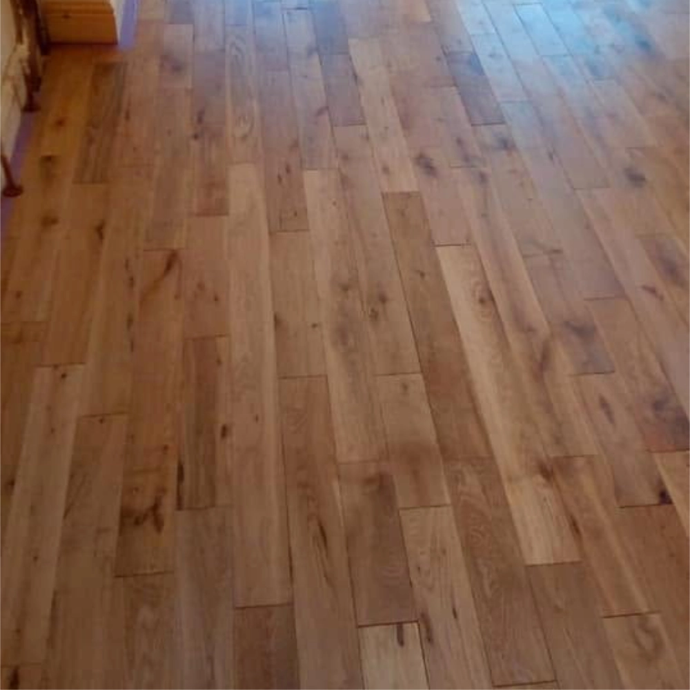 Wood-effect flooring fitted throughout a bright open-plan room