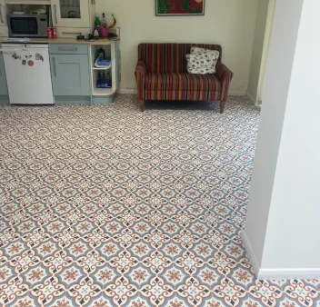 Decorative patterned flooring fitted throughout a kitchen and living area